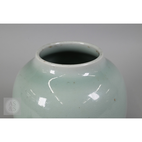 311 - An 18th century Chinese celadon jar and cover, Yueyaer guan (月牙耳罐) with gilt metal mounts, the taper... 