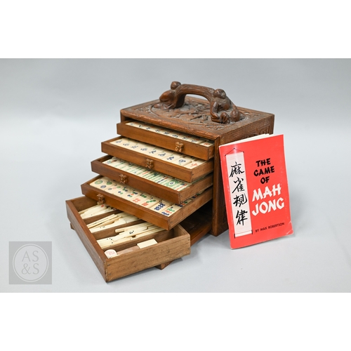 312 - An early-mid 20th century Chinese Mah Jong set, the wooden case decoratively carved with landscapes ... 