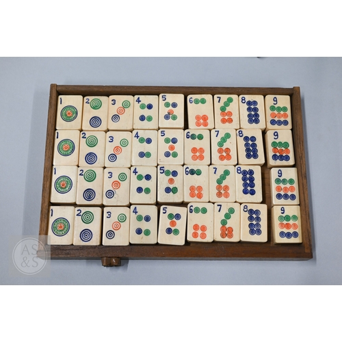 312 - An early-mid 20th century Chinese Mah Jong set, the wooden case decoratively carved with landscapes ... 