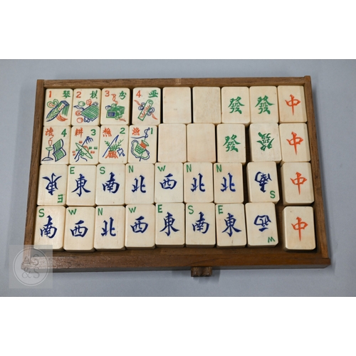 312 - An early-mid 20th century Chinese Mah Jong set, the wooden case decoratively carved with landscapes ... 