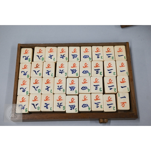 312 - An early-mid 20th century Chinese Mah Jong set, the wooden case decoratively carved with landscapes ... 