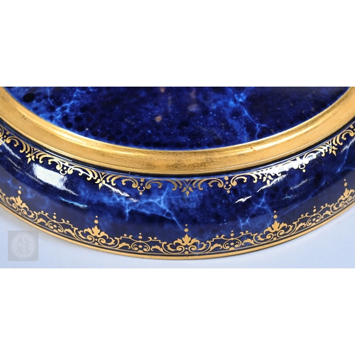 496 - A large Sèvres porcelain comport with revolving bowl top, decorated with gilding on a marbled blue g... 