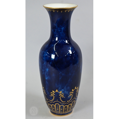 496 - A large Sèvres porcelain comport with revolving bowl top, decorated with gilding on a marbled blue g... 