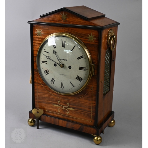 J Richmond, Chelmsford, a George III brass inlaid and ebony edged satinwood twin fusee bracket clock, with pull cord hour repeat brass  movement striking on a bell, the enamelled convex dial with roman numerals, the case with arched pierced brass fish scale panels, the movement enclosed by a glazed door, raised on brass ball feet, 45.5 cm h