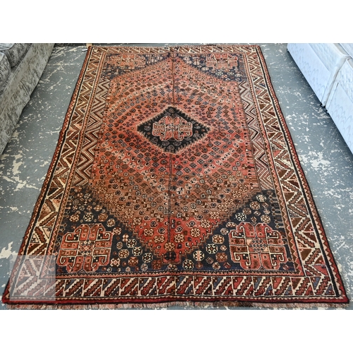 South West Persian Qashqai carpet, blue medallion and radiating boteh on terracotta ground with serrated leaf borders, 250 x 168 cm