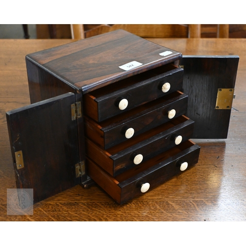 582 - A 19th century rosewood collector's cabinet with twin doors enclosing four drawers with bone handles... 