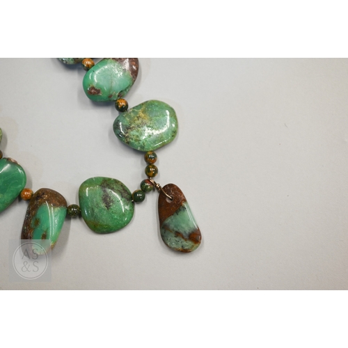 470 - A hardstone and iridescent ammonite necklace, a lapis lazuli bead necklace and a green chalcedony st... 