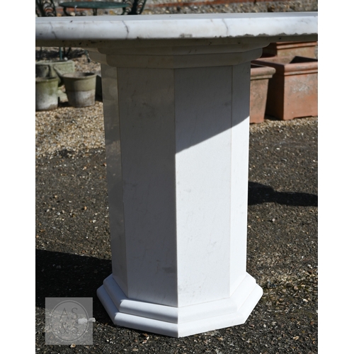 9 - A contemporary circular veined white marble top table raised on a conforming octagonal base, 120 cm ... 
