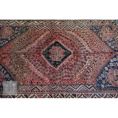113 - A South West Persian Qashqai carpet, blue medallion and radiating boteh on terracotta ground with se... 