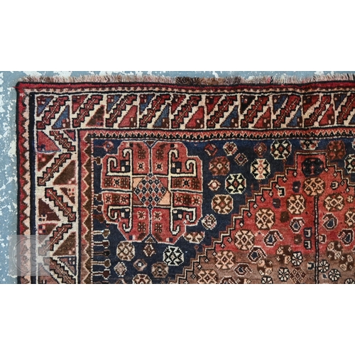 113 - A South West Persian Qashqai carpet, blue medallion and radiating boteh on terracotta ground with se... 