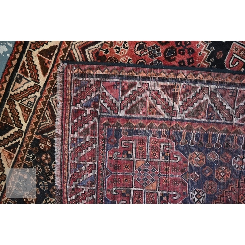 113 - A South West Persian Qashqai carpet, blue medallion and radiating boteh on terracotta ground with se... 