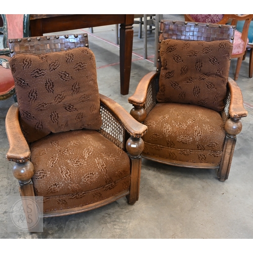59 - A pair of oak and leather bergere armchairs (2)