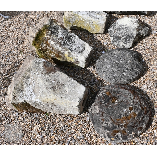 18 - A trio of antique granite staddle stones, of square tapering form, with circular caps, rough hewn an... 