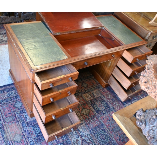 33 - A large antique mahogany twin pedestal desk, in three sections, the green inset skiver top with hing... 