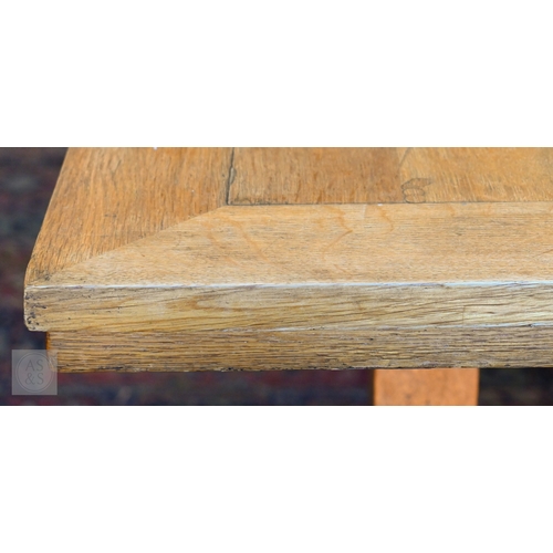 34 - A large oak refectory dining table, the framed wide plank top raised on square supports united by a ... 