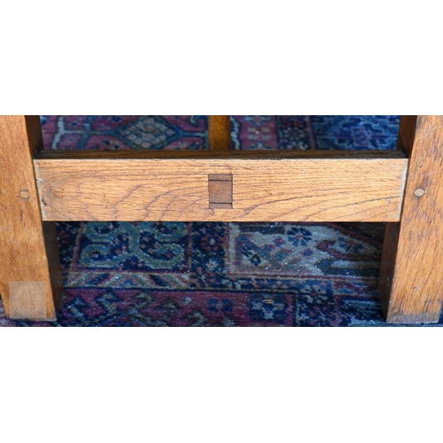 34 - A large oak refectory dining table, the framed wide plank top raised on square supports united by a ... 