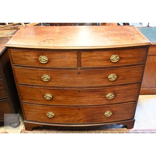 35 - A Victorian mahogany bowfront chest of two short over three long graduated drawers, with oval brass ... 