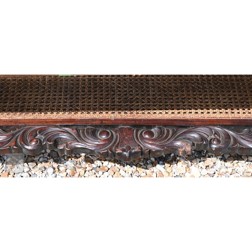 37 - A glass-topped Chippendale style coffee table with caned panel and conforming under tier, 139 cm x 7... 