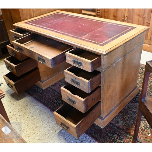 39 - An Edwardian oak twin pedestal desk, the top with inset gilt tooled burgundy leather skiver over nin... 