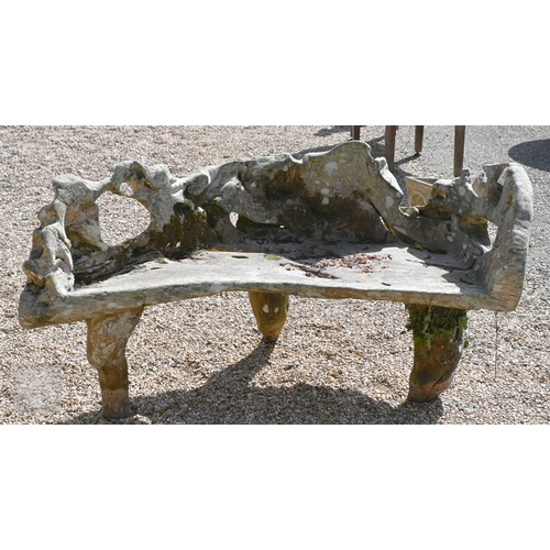 4 - An artisan sculptured solid teak root garden bench, weathered, 150 cm long
