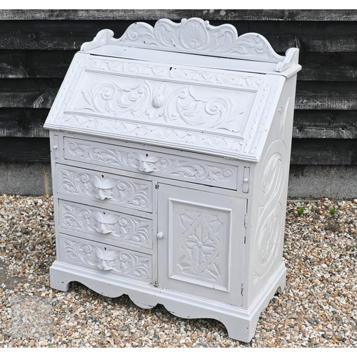44 - An antique carved oak bureau later painted pale grey, with carved lion mask drawer pulls and 3/4 gal... 