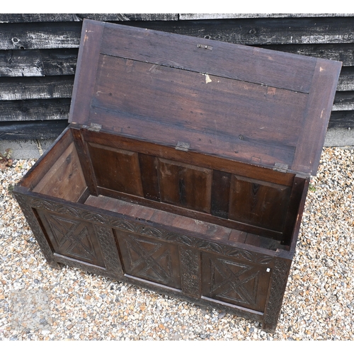 50 - An 18th century style oak coffer with triple carved panelled front, 130 cm x 53.5 cm x 64 cm h