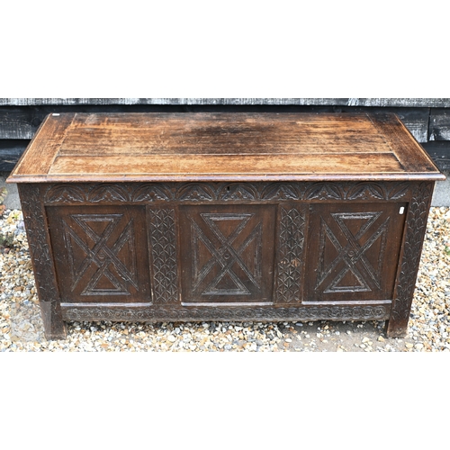 50 - An 18th century style oak coffer with triple carved panelled front, 130 cm x 53.5 cm x 64 cm h