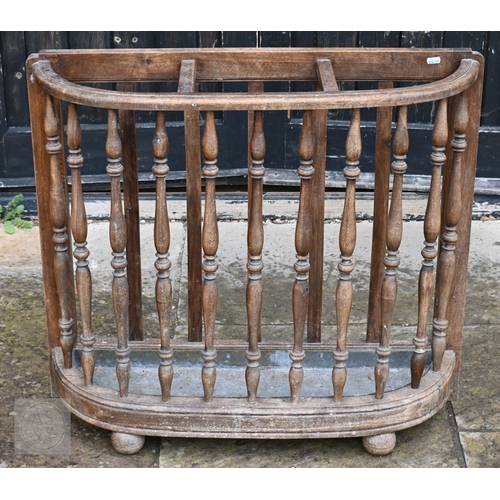 54 - An antique oak demi-lune form three division stick stand, with turned spindles and zinc drip tray, 8... 