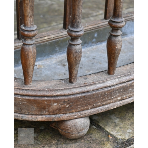 54 - An antique oak demi-lune form three division stick stand, with turned spindles and zinc drip tray, 8... 