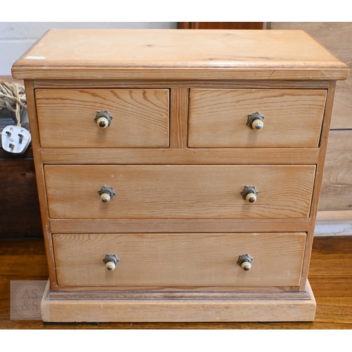 57 - An old pine miniature chest of two short over two long drawers, 43 cm x 22 cm x 42 cm h