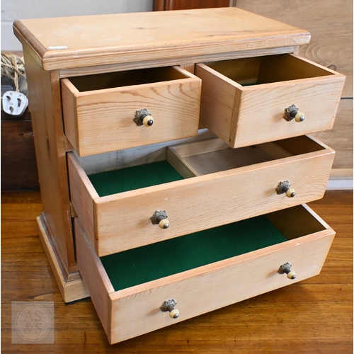 57 - An old pine miniature chest of two short over two long drawers, 43 cm x 22 cm x 42 cm h