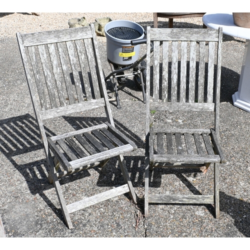 6 - A weathered teak lattice back box bench to/with a pair of folding teak chairs, all a/f (3)