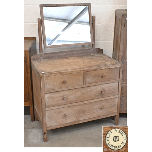 69 - Heal & Son, London - a limed oak mirror back dressing chest with four drawers, ivorine plaque to... 