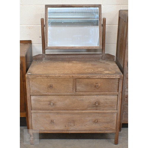 69 - Heal & Son, London - a limed oak mirror back dressing chest with four drawers, ivorine plaque to... 