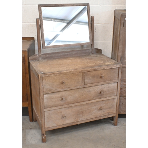 69 - Heal & Son, London - a limed oak mirror back dressing chest with four drawers, ivorine plaque to... 