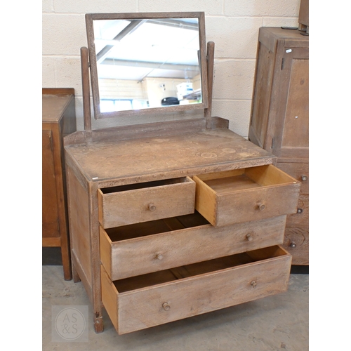 69 - Heal & Son, London - a limed oak mirror back dressing chest with four drawers, ivorine plaque to... 