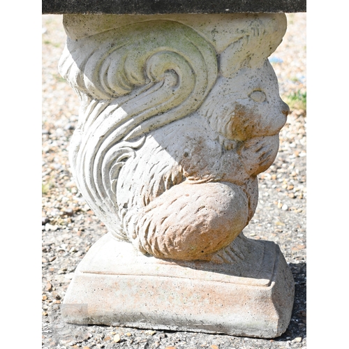 13 - A weathered three piece cast stone garden bench, the curved seat raised on 'squirrel' bases, 104 cm ... 
