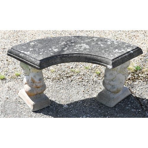 13 - A weathered three piece cast stone garden bench, the curved seat raised on 'squirrel' bases, 104 cm ... 