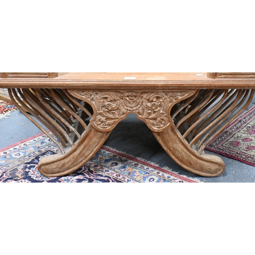 51 - An Asian teak open armchair in the form of a howdah, carved with galleried sides and spindles, 107 c... 