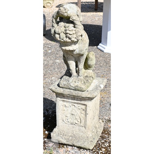 15 - A weathered cast stone garden statue on plinth - a hound bearing cornucopia basket, 96 cm h