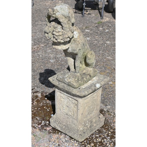 15 - A weathered cast stone garden statue on plinth - a hound bearing cornucopia basket, 96 cm h