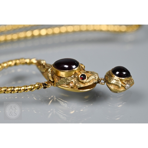 205 - An antique snake/serpent necklace, the snake head mounted with cabochon garnets and holding a heart-... 