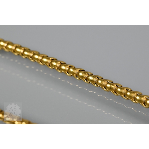205 - An antique snake/serpent necklace, the snake head mounted with cabochon garnets and holding a heart-... 