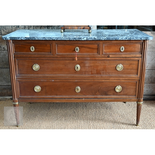 602 - A French Empire brass mounted three drawer marble top commode, 19th century, raised on turned fluted... 