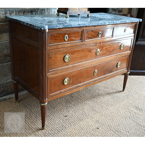 602 - A French Empire brass mounted three drawer marble top commode, 19th century, raised on turned fluted... 