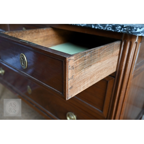 602 - A French Empire brass mounted three drawer marble top commode, 19th century, raised on turned fluted... 