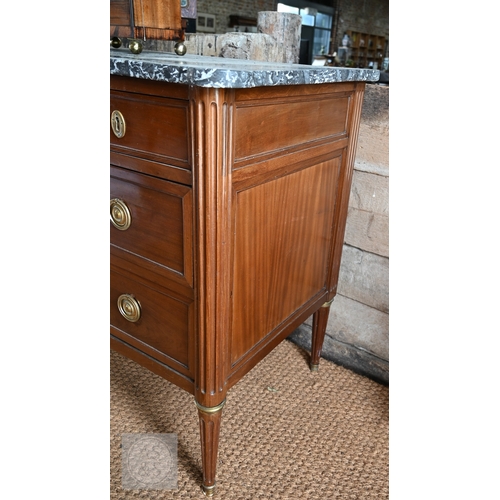 602 - A French Empire brass mounted three drawer marble top commode, 19th century, raised on turned fluted... 