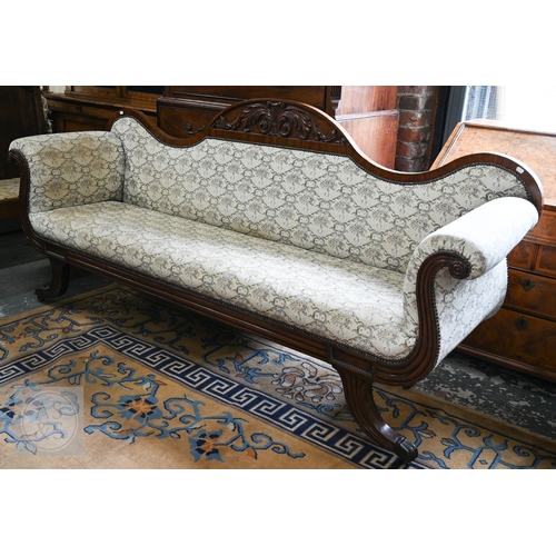 676 - A Regency mahogany show framed sofa, the arched crest centred foliate moulding in relief, over scrol... 