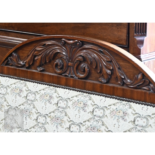 676 - A Regency mahogany show framed sofa, the arched crest centred foliate moulding in relief, over scrol... 