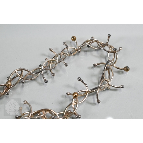 142 - Yen Duong - A silver curved 'molecule' necklace/choker, approx 40 cm long (open), 74.5g